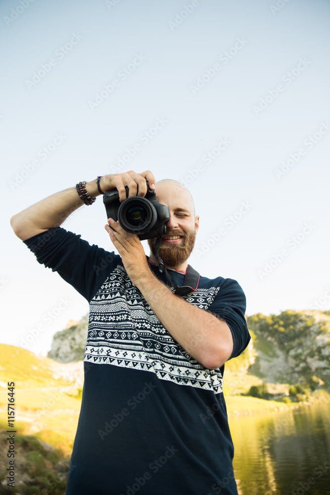 Bold man with a camera in a lake Bold man with a camera in a lake