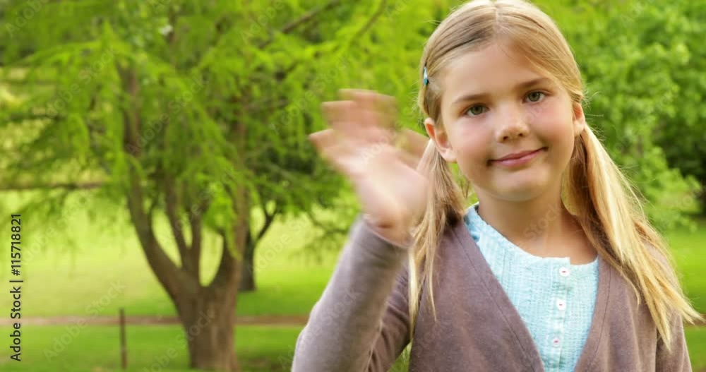 Cute little girl smiling and waving Cute little girl smiling and waving
