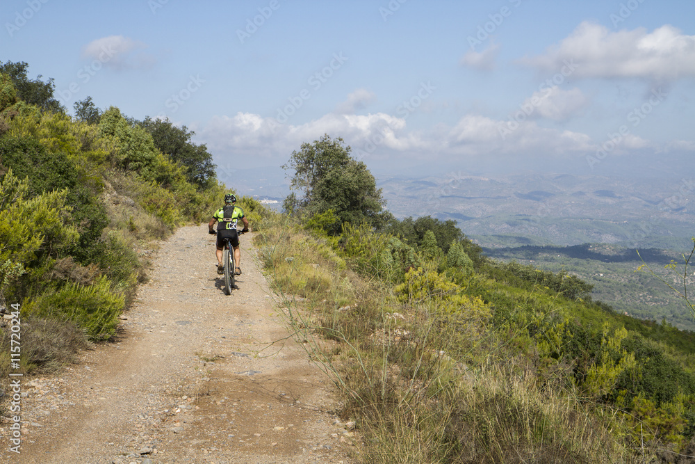 Cyklist på mountainbike cyklar i de spanska bergen