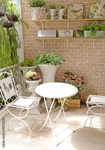 terrace or balcony with small table, chair and flowers
