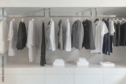 black and white color tone clothes hanging on rail