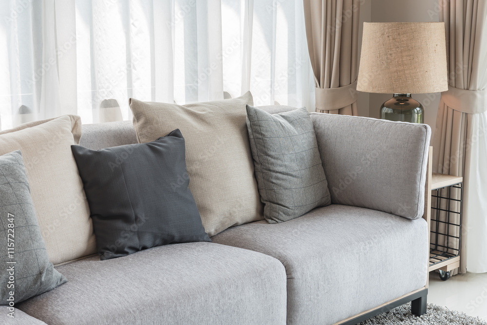 modern grey sofa with pillows and modern lamp on table side in l modern grey sofa with pillows and modern lamp on table side in l