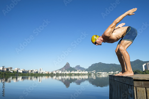 Athlete swimmer with yellow swimming cap in the start position for a race at the Lagoa Rodrigo de Freitas lagoon in Rio de Janeiro, Brazil