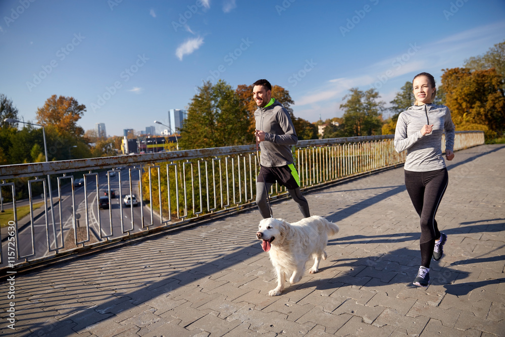 happy couple with dog running outdoors happy couple with dog running outdoors