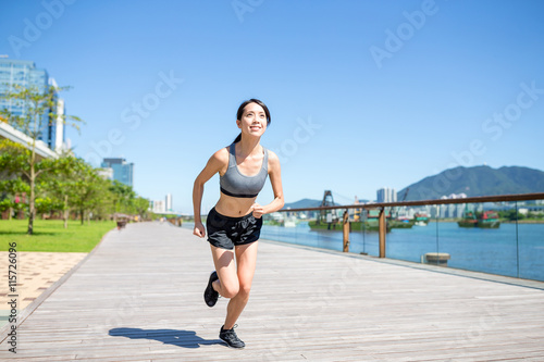 Female running in city © leungchopan
