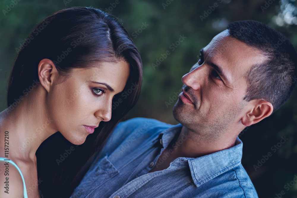 Fototapeta premium Troubled couple hugging in the park