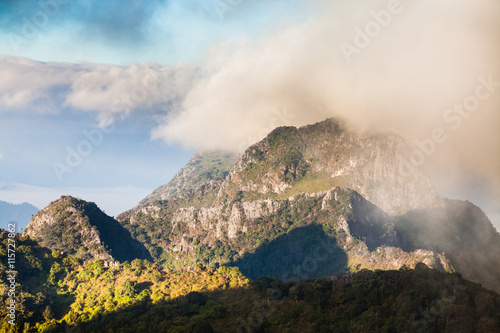 mountain peak and raining fog blue sky