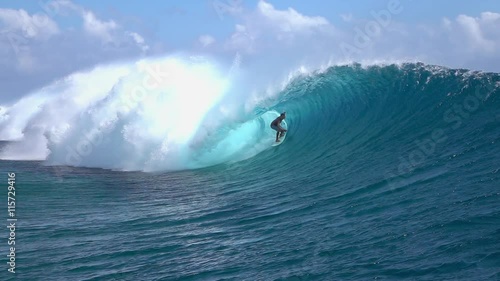 SLOW MOTION: Extreme surfer surfing inside big tube barrel wave