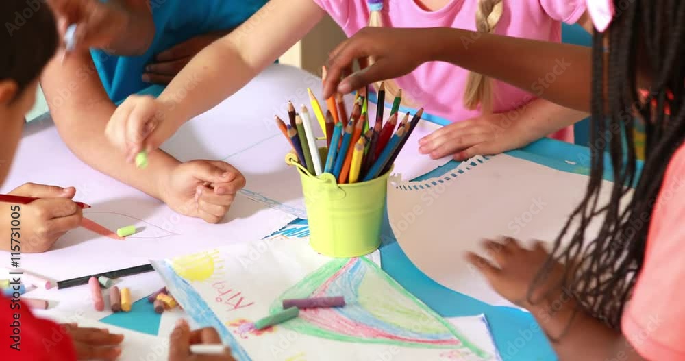 Preschool class drawing at table in classroom Preschool class drawing at table in classroom