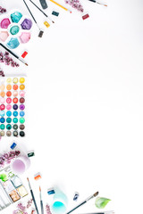 Watercolor and brushes at white background. Flat lay, top view