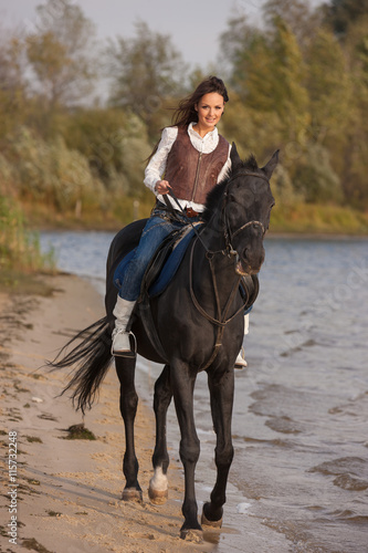 Beautiful cowgirl riding horse