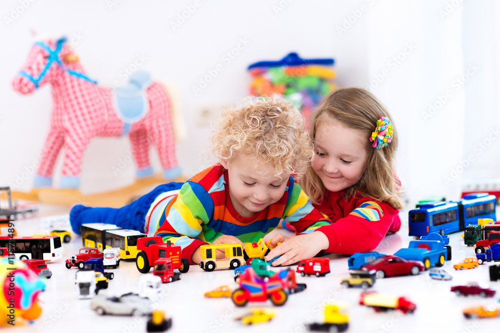 Fototapeta premium Little kids playing with toy cars