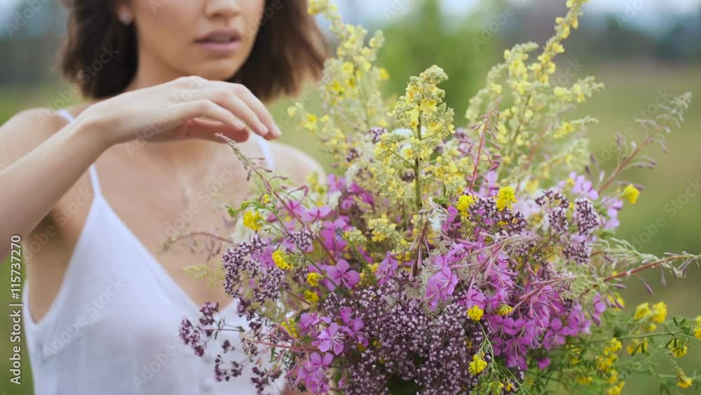 Summer flowering field and a beautiful girl in a white sundress. Summer flowering field and a beautiful girl in a white sundress.