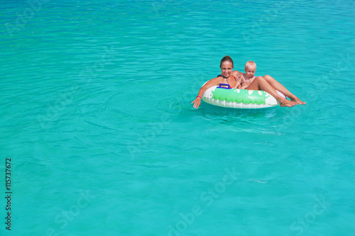 Funny happy family in turquoise beach pool - mother, baby son swim, sunbathing with fun. Healthy lifestyle, active parent, people water sports activity and swimming lesson on summer holiday with child © Tropical studio