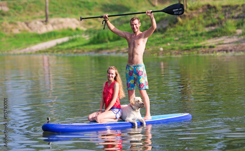 Obraz na płótnie Outdoor recreation. Two in the boat and a dog. w salonie