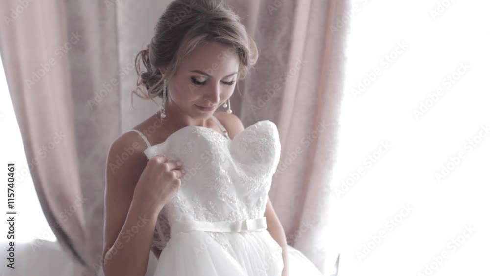 Beautiful bride in underweare tries on a wedding dress Beautiful bride in underweare tries on a wedding dress