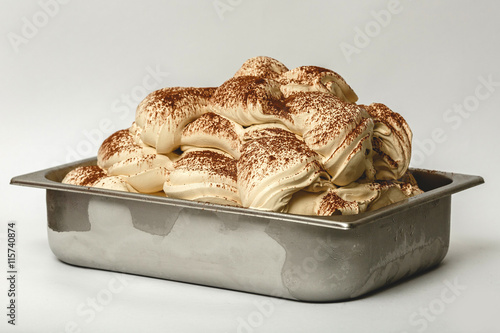 Tiramisu ice cream in the metal tray on white background