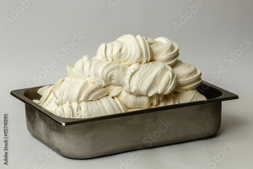 White ice cream in the metal tray on white background