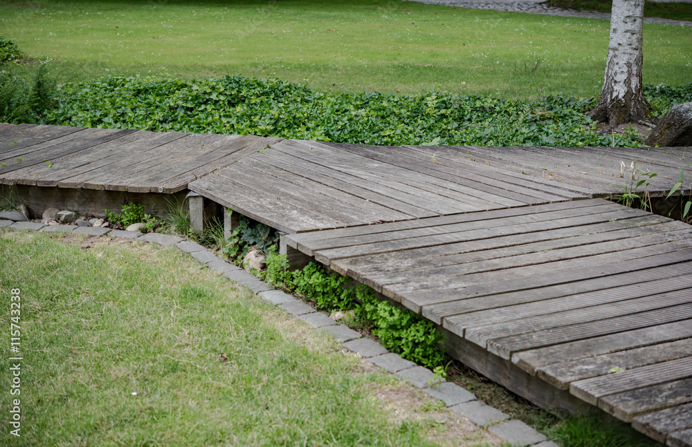 Fototapeta premium Wooden bridge in a forest along the trekking path