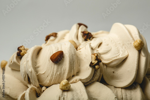 Ice cream with different kinds of nuts in the metal tray on white background