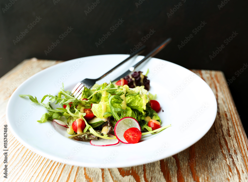 Green mixed salad with folk and knife Green mixed salad with folk and knife