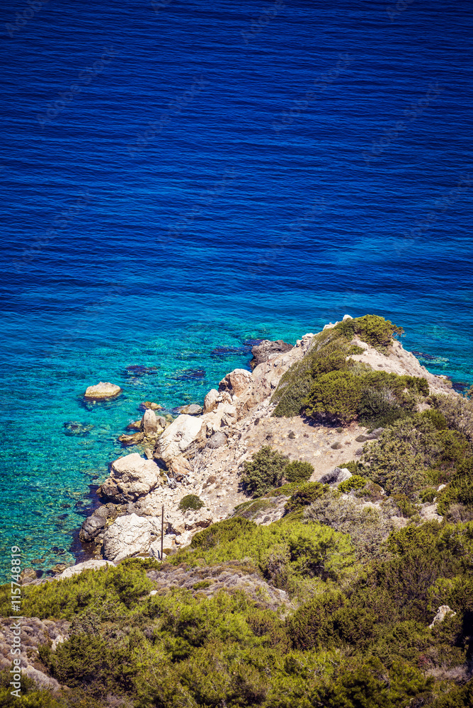 View of rocky shore beach with turquoise water View of rocky shore beach with turquoise water