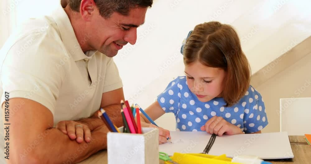 Father and daughter drawing together at the table Father and daughter drawing together at the table