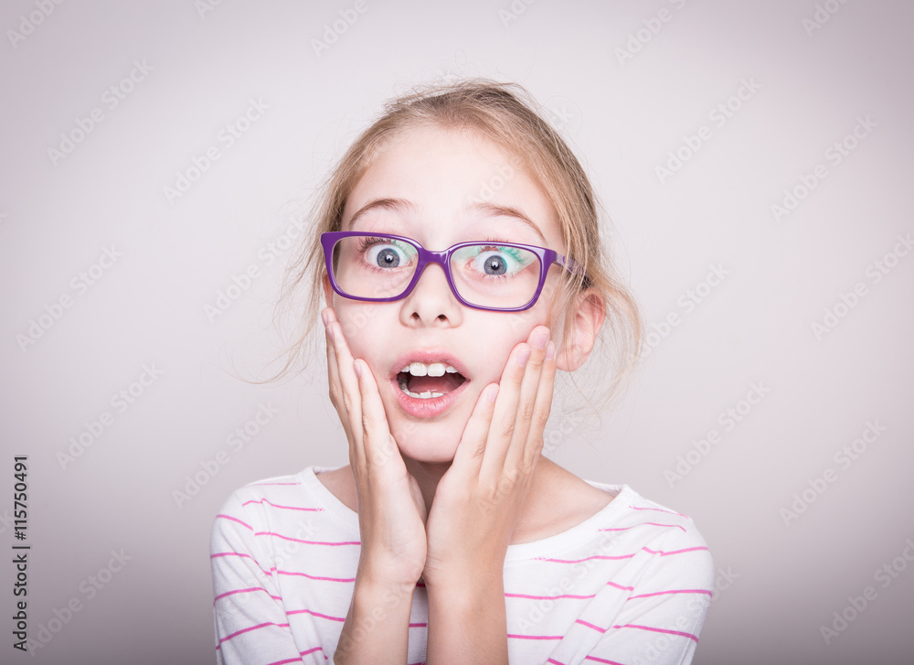Surprised or shocked face of child girl in violet glasses Surprised or shocked face of child girl in violet glasses