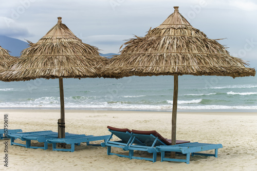 Palm shelter and sunbeds in the Beach in Da Nang