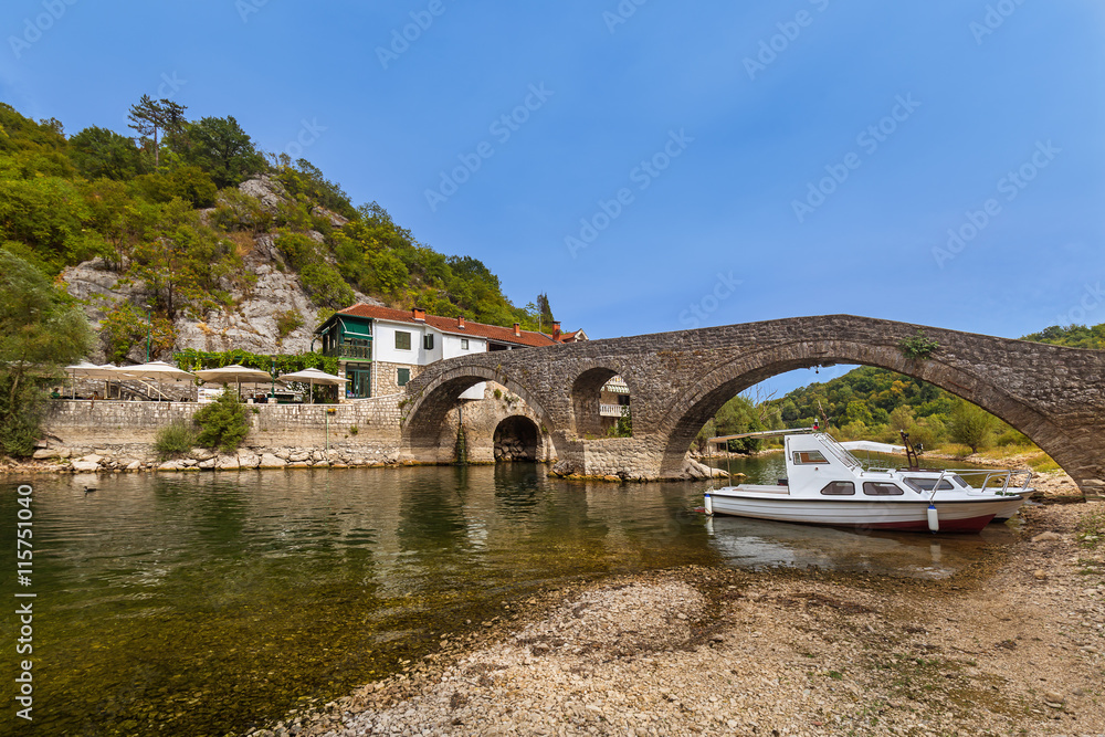 Naklejka premium Old Bridge in Rijeka Crnojevica River near Skadar Lake - Montene