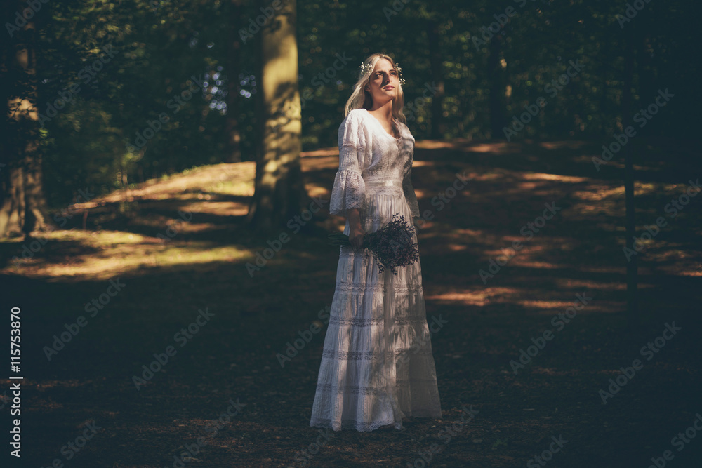 Blonde bride catching sunlight in forest Blonde bride catching sunlight in forest