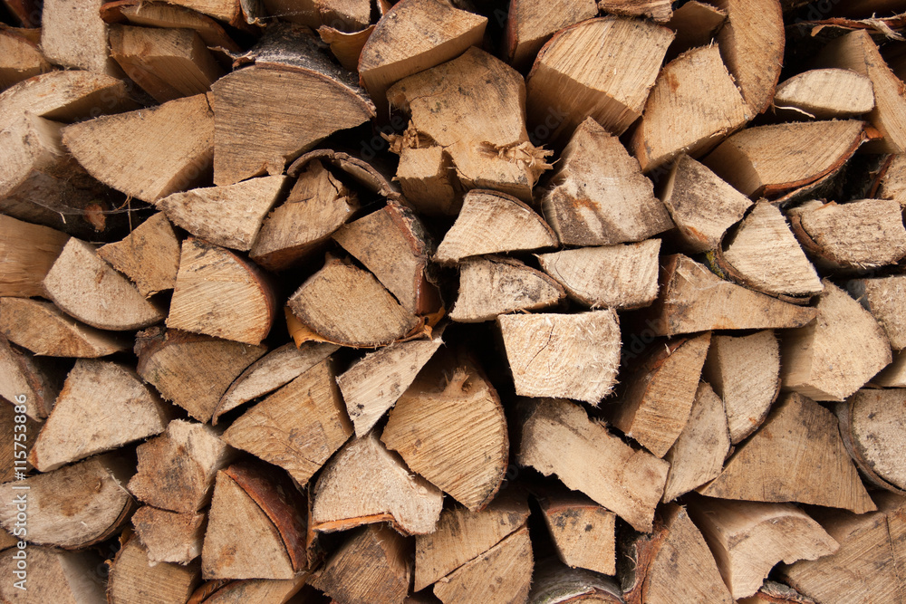 Stacked chopped firewood as background Stacked chopped firewood as background
