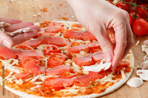 Cooking homemade pizza with...
