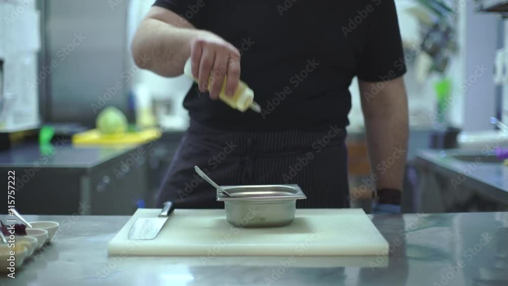 Chef prepares a meat dish in the kitchen of a restaurant Chef prepares a meat dish in the kitchen of a restaurant