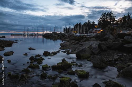 Long Exposure Picture of the river meeting the ocean in Horseshoe Bay, Vancouver, British Columbia, Canada. Taken after a beautiful cloudy sunset.