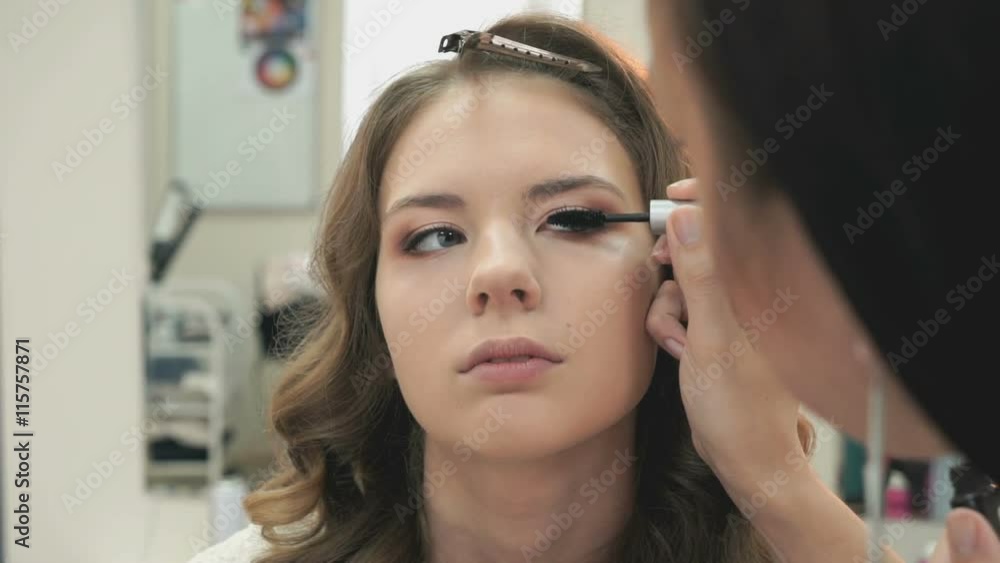 Makeup artist making make-up for a girl Makeup artist making make-up for a girl
