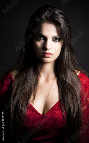 Beauty brunette girl with make-up.elegant lady in red dress