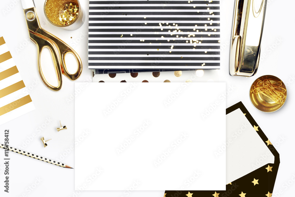 Flat lay, office white desk and envelope with gold stationery. Gold