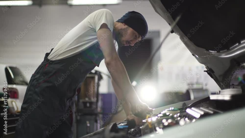 Auto mechanic repair engine in a car repair shop Auto mechanic repair engine in a car repair shop