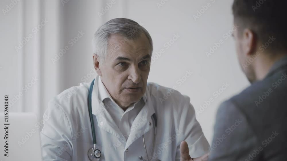 Senior doctor consults young patient Senior doctor consults young patient