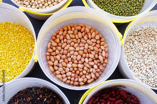 Mixed beans and lentils of different legumes on black background
