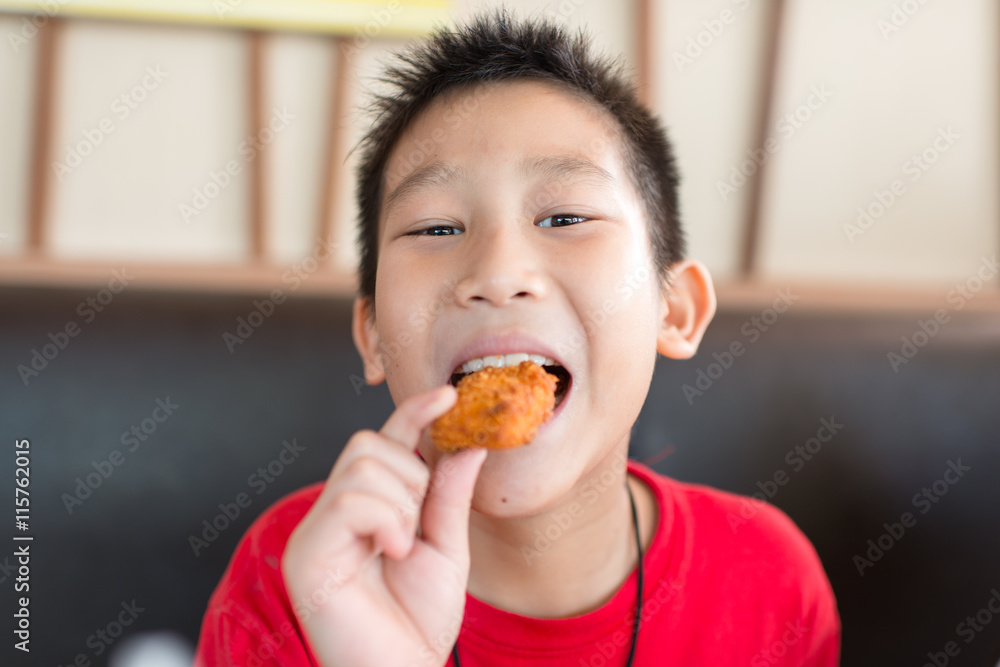 Happy Asian child eating fast food Happy Asian child eating fast food