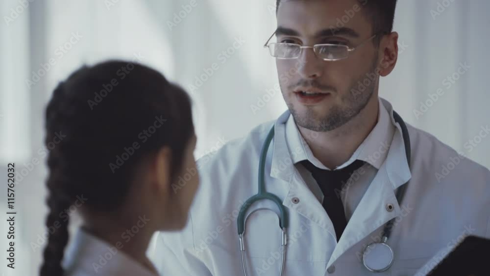 Pediatrician doctor examining little girl in a clinic Pediatrician doctor examining little girl in a clinic