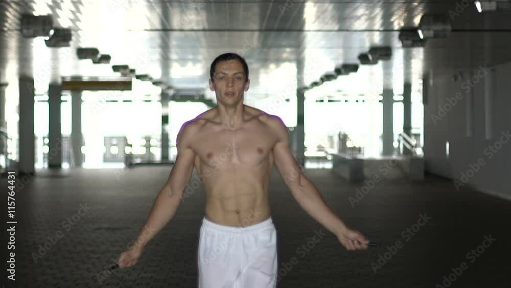 Silhouette of athlete trains with a jump rope. Slow motion Silhouette of athlete trains with a jump rope. Slow motion