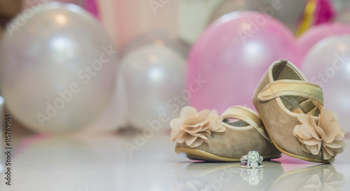 seletive focus Bride and groom's wedding ring put forward shoes with bollon bokeh background