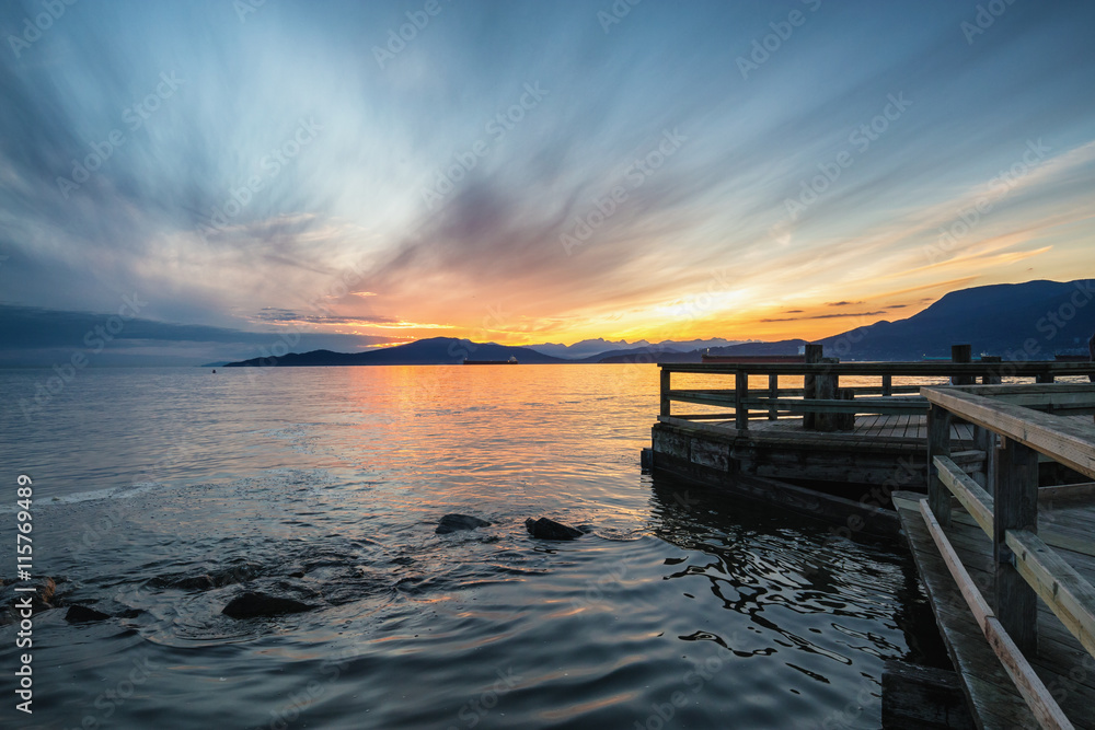 Beautiful sunset viewed from a dock in Jericho Beach, Vancouver, British Columbia, Canada.