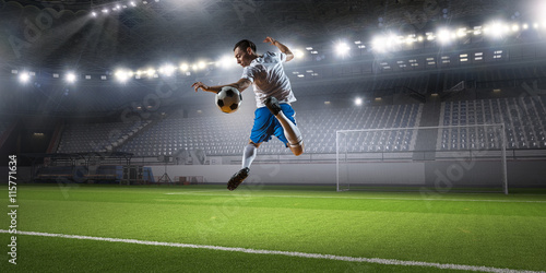 Soccer player hitting ball . Mixed media