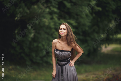 Close up Portrait, Young beautiful blonde woman in dress posing outdoors. Sunny weather © olegparylyak