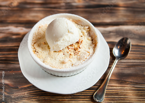 Tasty dessert with an ice cream ball on a wooden background