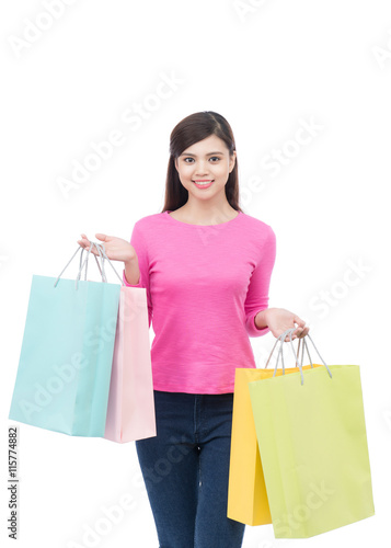 Beautiful young asian woman holding colored shopping bags